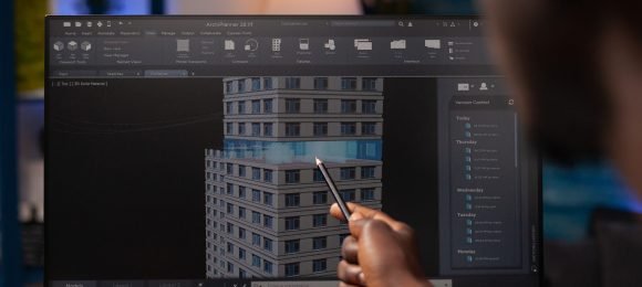 Architect engineer pointing at architectural building prototype analyzing construction model on computer. Businessman designer working remote from home at real estate project modeling sketch